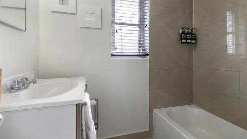 a white bathroom with a sink and a shower at Brickell 4ever Apartment Beach 10 minutes Location in Miami