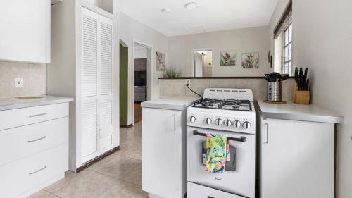 a kitchen with a white stove and white cabinets at Brickell 4ever Apartment Beach 10 minutes Location in Miami