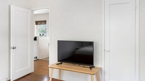 a flat screen tv sitting on a table in a room at Brickell Tree Apartment Beach 10min Location Shops in Miami