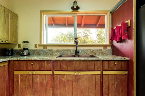 a kitchen with a sink and a window at Hawaiian Asian Vacation House in Pahoa