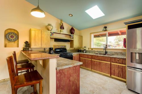 a kitchen with wooden cabinets and a stove top oven at Hawaiian Asian Vacation House in Pahoa