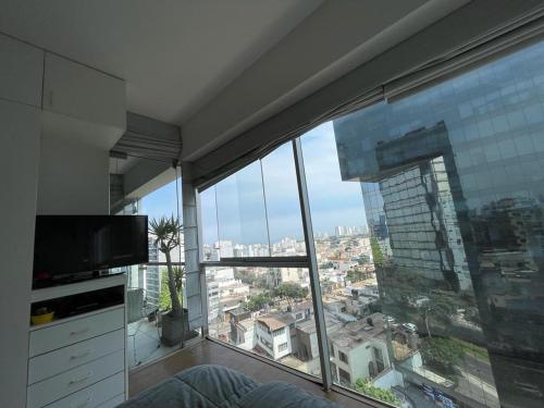 a room with a large window with a view of a city at Departamento Family in Lima