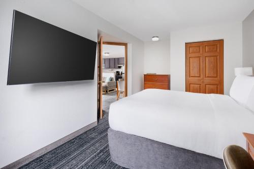 a hotel room with a bed and a flat screen tv at TownePlace Suites Philadelphia Horsham in Horsham