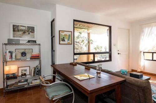 a living room with a table and a couch at Authentic Loft Retreat Steps from Beach & Culture in San José del Cabo