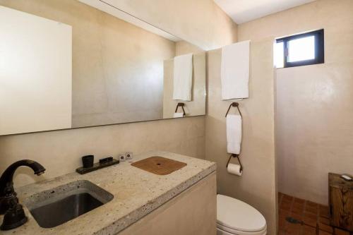 a bathroom with a sink and a toilet at Authentic Loft Retreat Steps from Beach & Culture in San José del Cabo