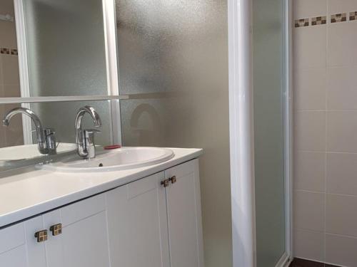 une salle de bain blanche avec un lavabo et une douche dans l'établissement Charmant studio 4 pers. 32 m², balcon Sud, télésiège à 50m – Alpe d’Huez - FR-1-405-222, à Huez