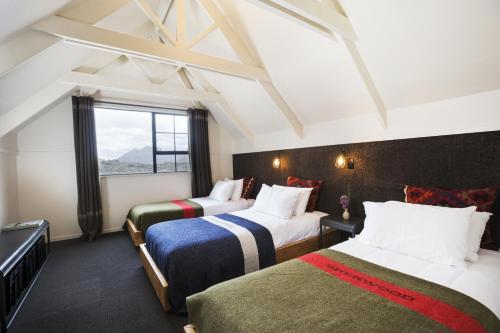 a hotel room with two beds and a large window at Sherwood in Queenstown