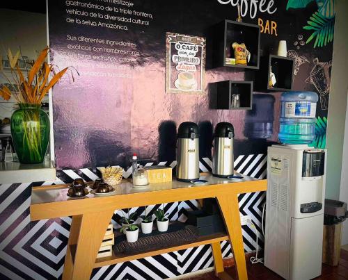 a table with two coffee machines on top of it at Zuruma Hotel in Leticia