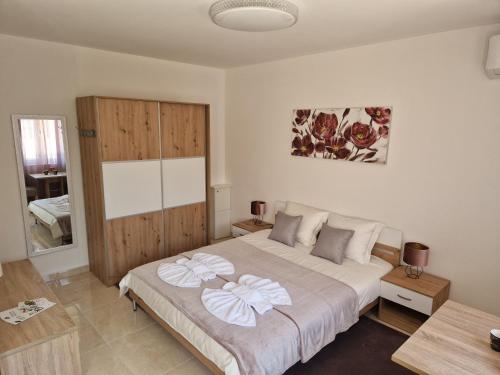 a bedroom with a large bed and a wooden cabinet at Sobe i apartmani Tena in Velika Gorica