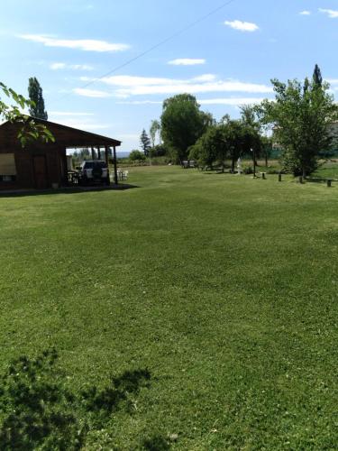 a large grass field with a pavilion in the distance at Cabañas RoFran in La Consulta