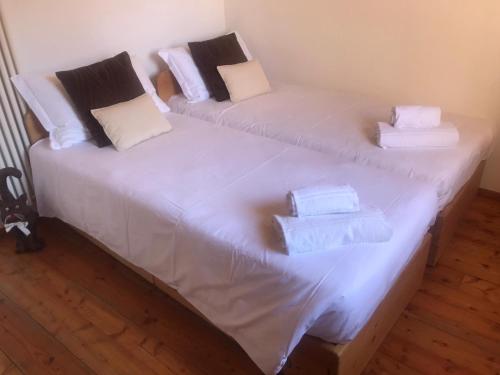 two beds with white sheets and towels on them at CASA TOFFOLI SOLIGO - locazioni turistiche in Soligo