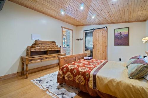 a bedroom with a bed and a wooden ceiling at Encore Cottonwoods Ski Cabin. in Sandy