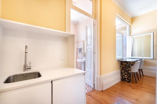 a kitchen with a sink and a window at Downtown Grand Houses in Porto
