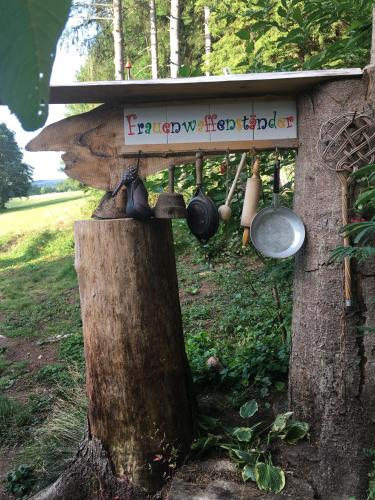 a mushroom house with pots and pans hanging from a tree at Waldnest Odenwald in Wald-Michelbach