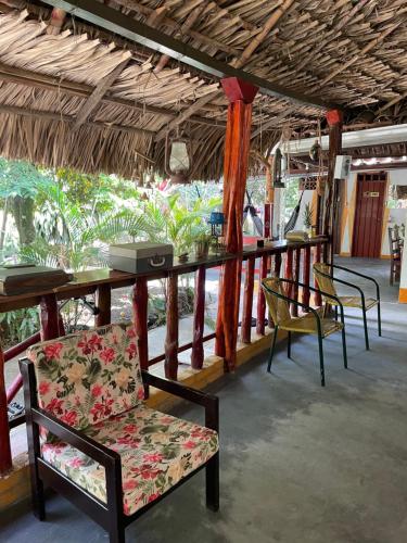 a room with chairs and a bar with a table at Ancestral Casa de Campo in Roldanillo