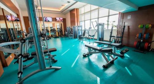 a gym with several tread machines in a room at Centaurus Apartment Islamabad in Islamabad