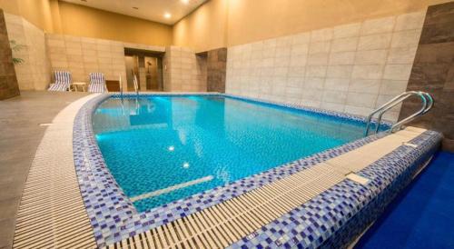 a large swimming pool in a hotel room at Centaurus Apartment Islamabad in Islamabad
