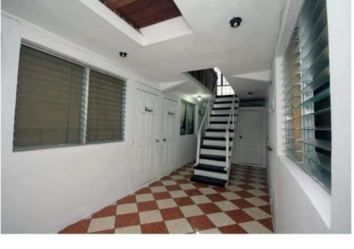 a hallway with a staircase in a house at Hotel El Castillo del Puerto in Puerto Barrios