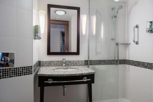 a bathroom with a sink and a shower at Hampton by Hilton Birmingham Broad Street in Birmingham