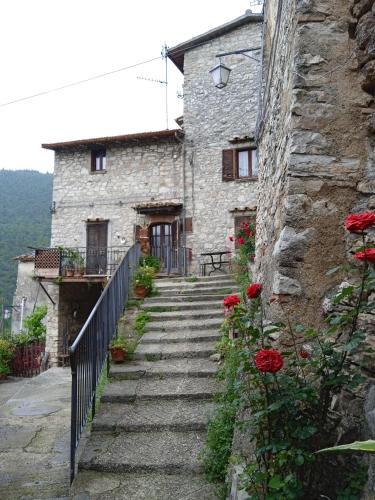 a stone house with stairs leading up to it at Casa Belvedere a Valle San Martino di Spoleto in Spoleto