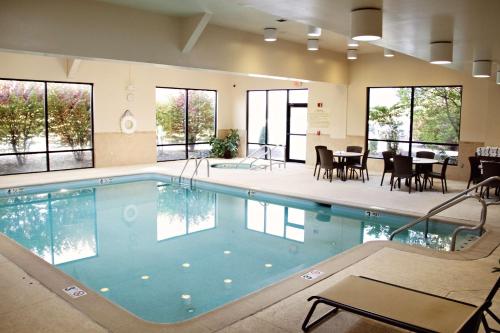 a large swimming pool with tables and chairs and windows at Hampton Inn Gettysburg in Gettysburg