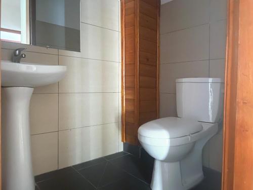 a bathroom with a white toilet and a sink at Residence Atlantic - Premium Apartment - WiFi, Gardien, Parking, Climaté in Douala