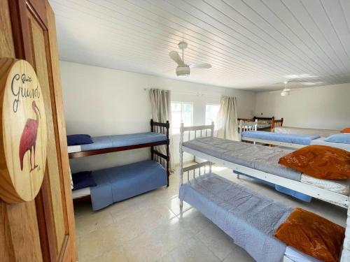 a room with four bunk beds in it with a ceiling at Casa Amarela Hostel in Guarapari