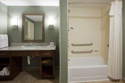 a bathroom with a tub and a sink and a shower at Homewood Suites by Hilton Rochester Mayo Clinic-St. Marys Campus in Rochester