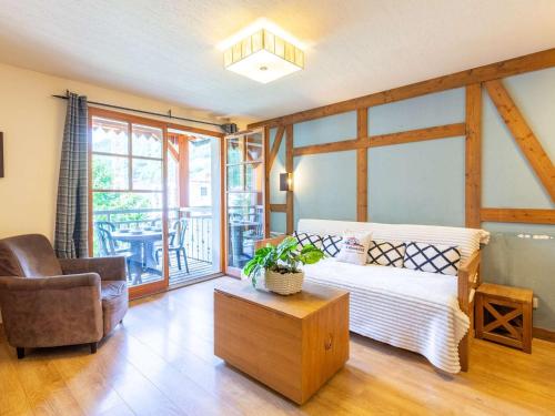 a bedroom with a bed and a chair and a table at Appartement Saint-Lary-Soulan, 4 pièces, 10 personnes - FR-1-296-394 in Saint-Lary-Soulan