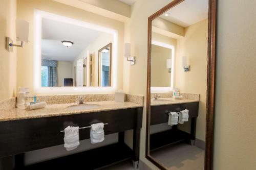 a hotel bathroom with two sinks and a mirror at Homewood Suites Nashville Airport in Nashville