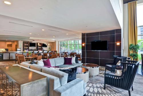 a living room with a couch and a table at DoubleTree by Hilton Hotel Baton Rouge in Baton Rouge
