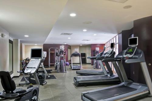 a gym with several treadmills and cardio machines at DoubleTree by Hilton Hotel Baton Rouge in Baton Rouge