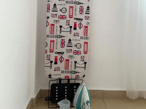 a wall with a banner with british sights at Residence Atlantic - Premium Apartment - WiFi, Gardien, Parking, Climaté in Douala