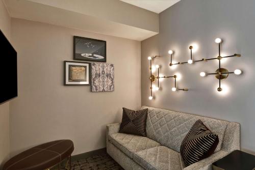 a living room with a couch and a chandelier at DoubleTree by Hilton Hotel Baton Rouge in Baton Rouge