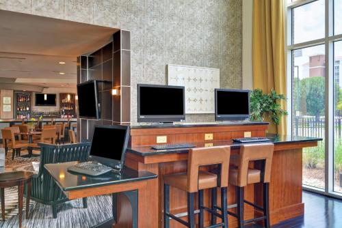 a lobby with a desk with two computer monitors on it at DoubleTree by Hilton Hotel Baton Rouge in Baton Rouge
