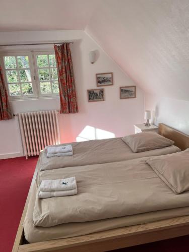 a bedroom with a large bed with two towels on it at Les Argousiers in Le Touquet-Paris-Plage