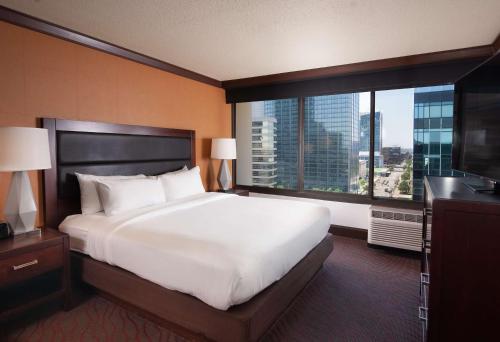 a bedroom with a large bed and a large window at DoubleTree by Hilton Hotel Cleveland Downtown - Lakeside in Cleveland