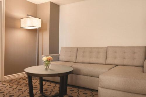 a living room with a couch and a table at Hilton Los Angeles/San Gabriel in San Gabriel