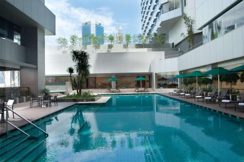 a swimming pool in the middle of a building at DoubleTree By Hilton Kuala Lumpur in Kuala Lumpur