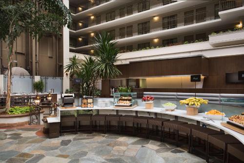 a lobby of a hotel with a buffet of food at Embassy Suites San Francisco Airport Waterfront in Burlingame