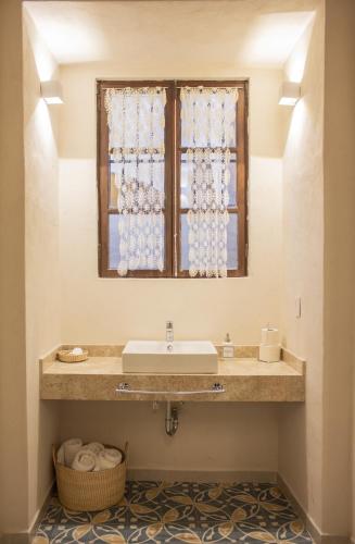a bathroom with a sink and a window at Casa Montespejo B&B in Querétaro