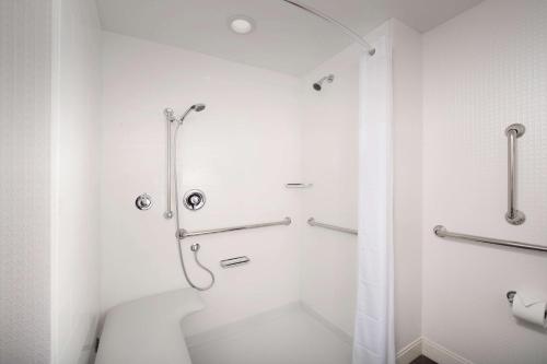 a white bathroom with a shower and a toilet at Hampton Inn Miami Airport East in Miami