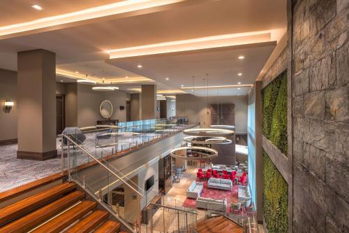 a lobby of a hotel with a staircase and a bar at Hilton Garden Inn Bogota Airport in Bogotá