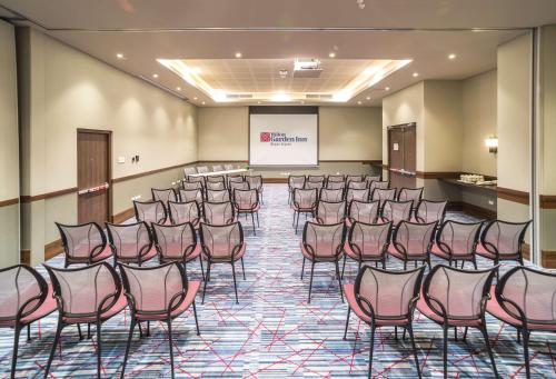 a conference room with chairs and a projector screen at Hilton Garden Inn Bogota Airport in Bogotá