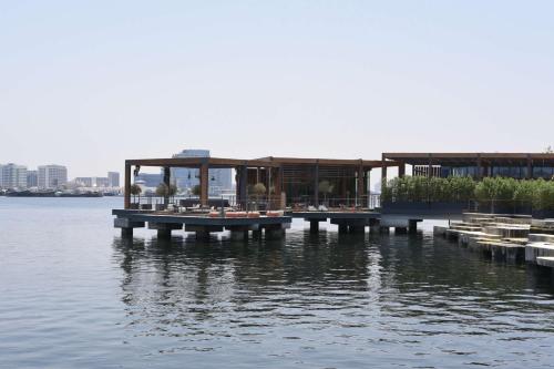 a house on a dock on a body of water at Canopy by Hilton Dubai Al Seef in Dubai
