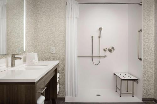a white bathroom with a sink and a shower at Home2 Suites By Hilton Columbus Polaris in Columbus