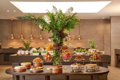 a buffet line with many different types of food at Hilton Garden Inn Seoul Gangnam in Seoul