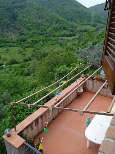 a balcony with a table and a view of a valley at Casa Belvedere a Valle San Martino di Spoleto in Spoleto