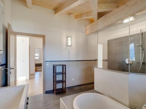 a bathroom with a large white tub and a sink at Chalet Pinzgau in Neukirchen am Großvenediger
