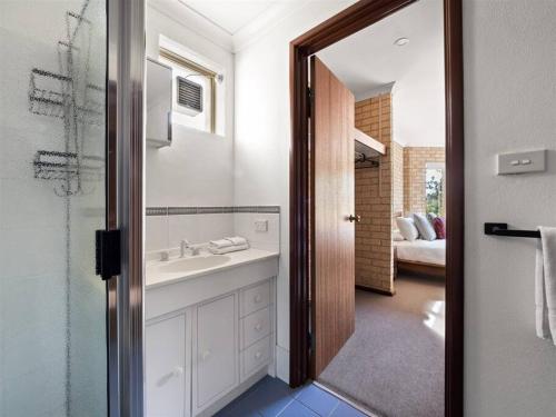 a bathroom with a sink and a mirror at Whale Watch Augusta Family Retreat in Augusta